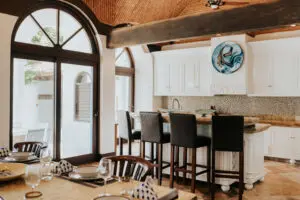 a kitchen area with four chairs