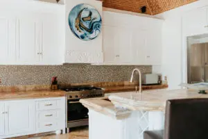 a kitchen in a villa with white cabinets