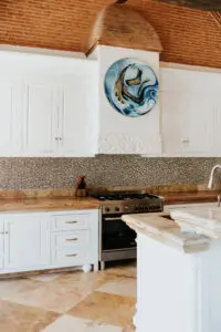 a kitchen area with white cabinets