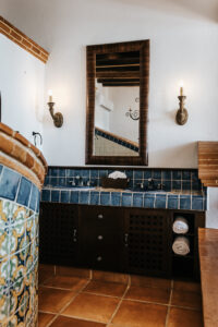 a washroom with two sinks and mirrors