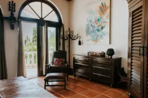 a room with large window, chair, and side table