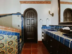 a bathroom with two sinks and a shower area