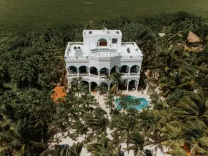 Front view of a beach villa with lots of trees taken from the top